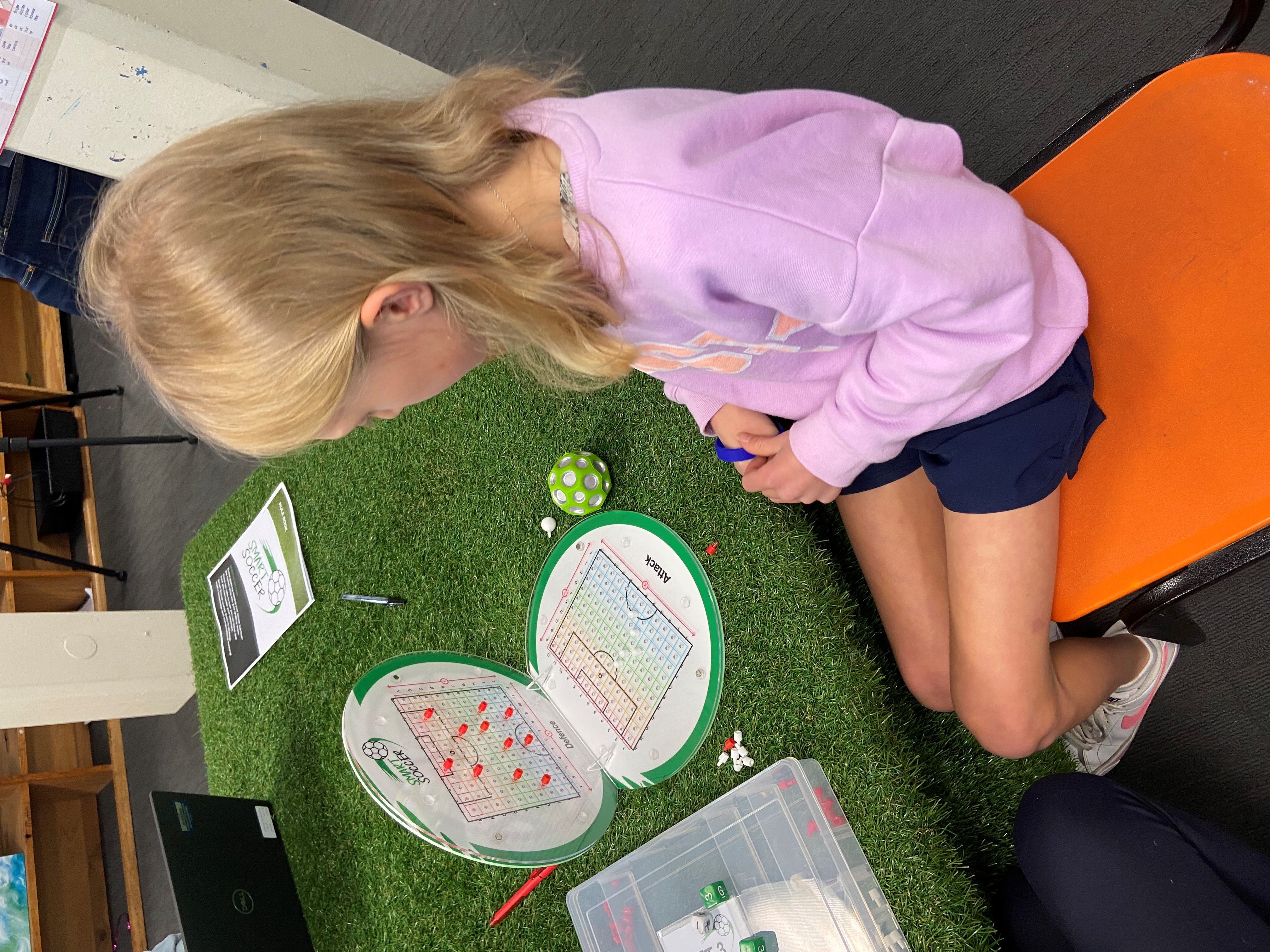 Student planning moves using the Smart Soccer board